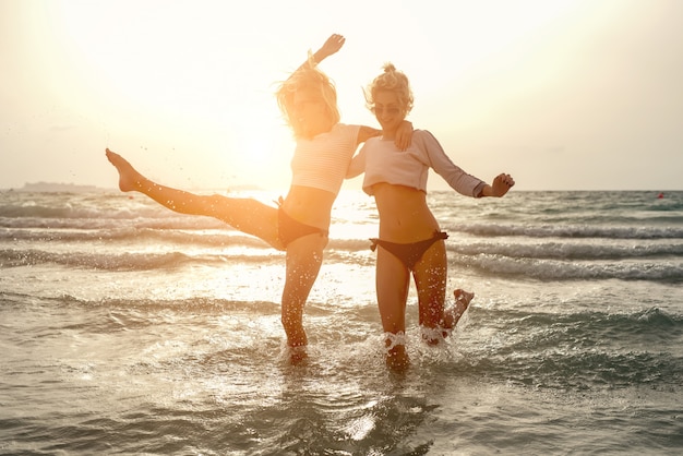 Two female friends enjoying in sea.