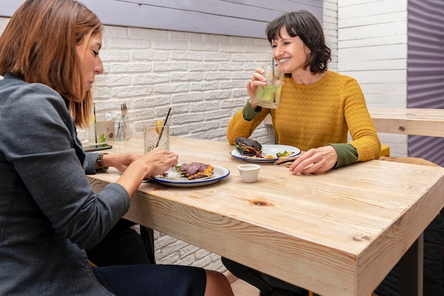 Two female friends enjoying vegetarian food