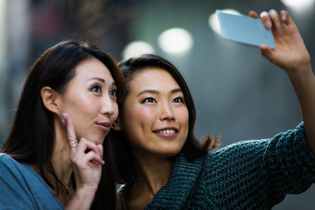 Two female friends meeting in Tokyo