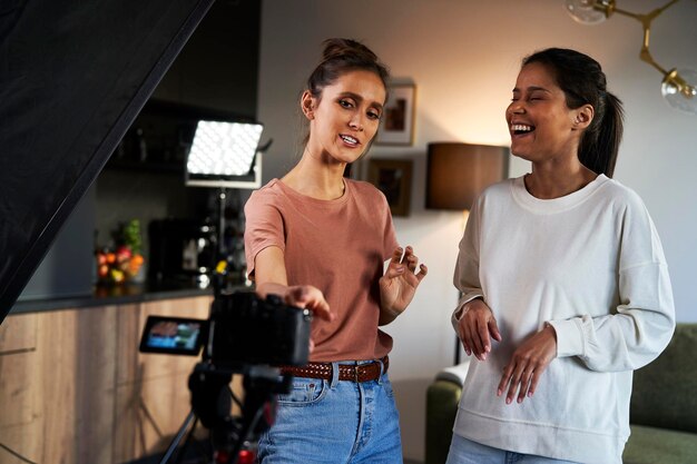 Photo two female women having fun while recording a video vlog