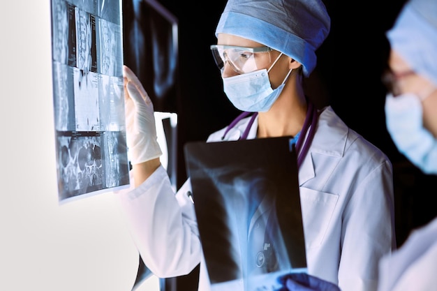 Two female women medical doctors looking at x-rays in a hospital