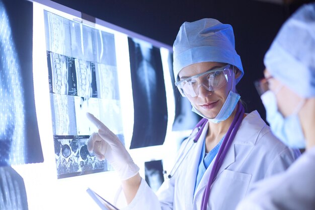 Two female women medical doctors looking at xrays in a hospital