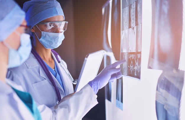 Two female women medical doctors looking at xrays in a hospital