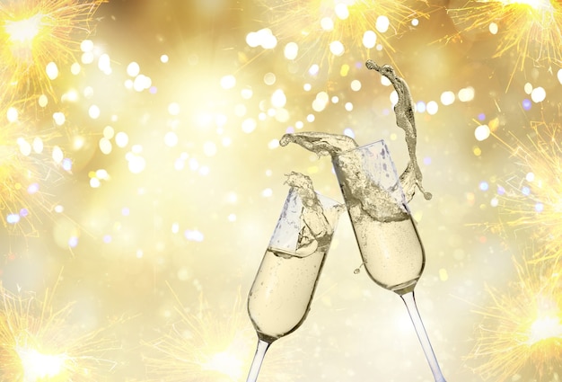 Photo two festive champagne glasses on golden bokeh background with lights and fireworks