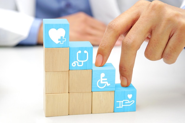 two fingers of doctor is walking up stairs wooden blocks with medical symbol icons