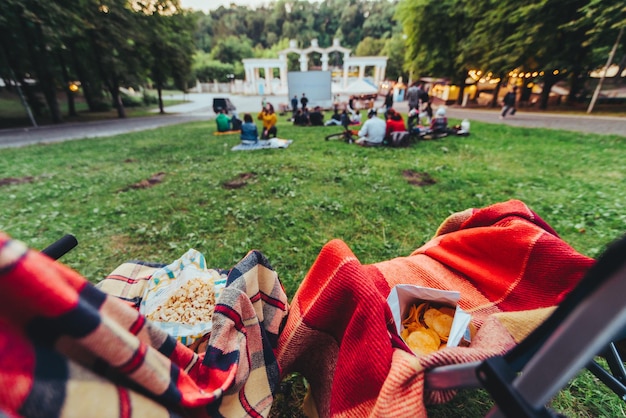 Two folding chairs with cooling bag with beer and snacks in open air cinema