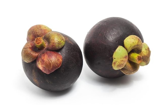 Two fresh organic mangosteen delicious fruit side view isolated on white background clipping path