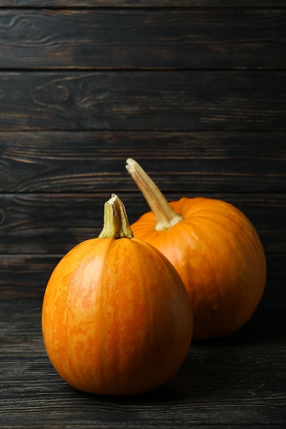 Two fresh pumpkins on rustic wooden background