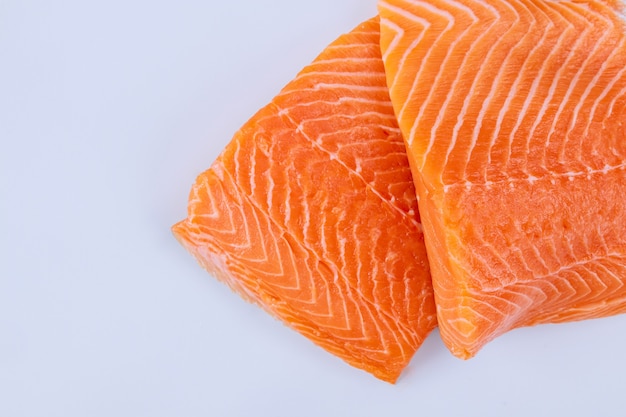 Two fresh raw salmon fillet with on a white