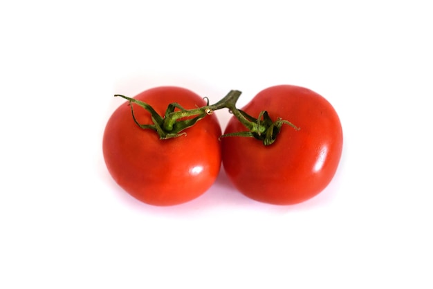 Two fresh red tomatoes isolated on a white background