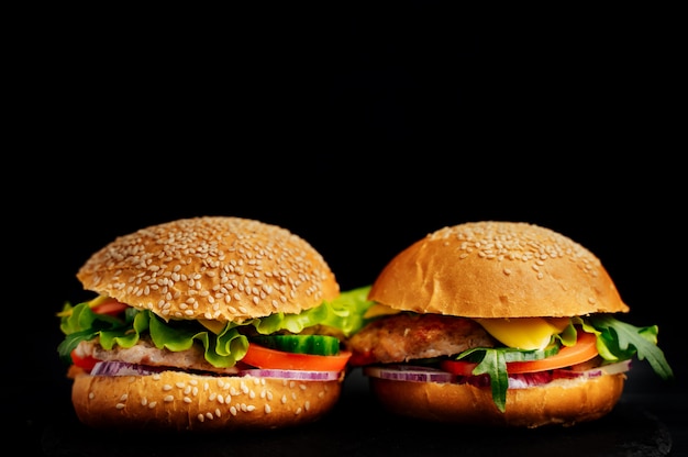 Two fresh tasty sandwiches isolated on black 