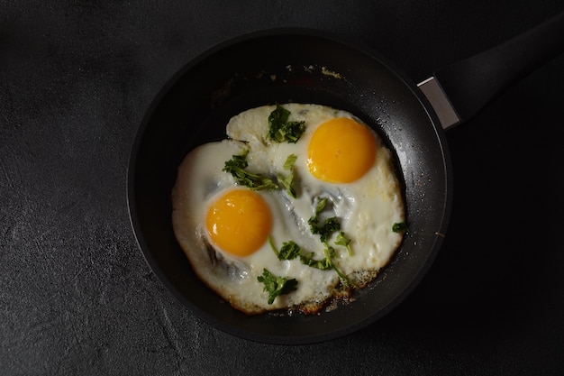 Two fried eggs in cast iron frying pan