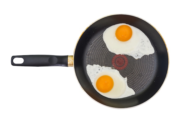 Photo two fried eggs in a frying pan isolated on white. top view. fried eggs from two eggs.