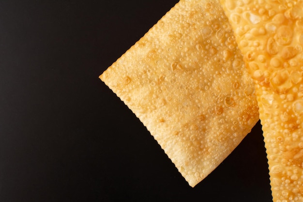 Two Fried Pastels Pastel de Feira black background Copy Space