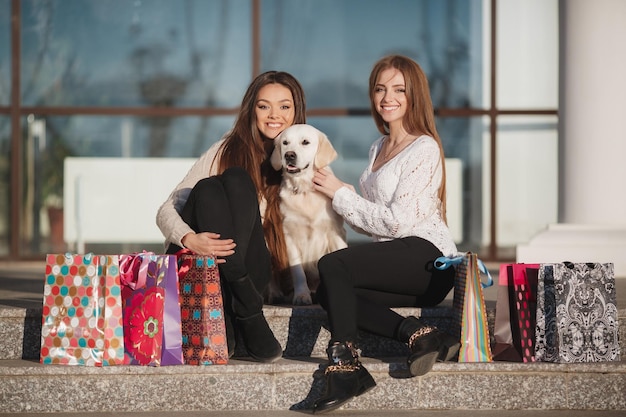 two friends after shopping outdoors