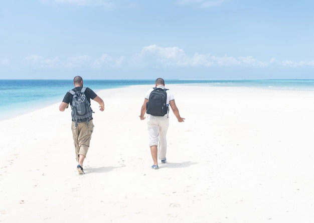 Two friends on beautiful hot beach enjoying