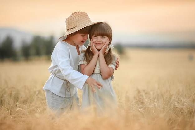 Two friends a boy and a girl hapines walk on the farm in the field