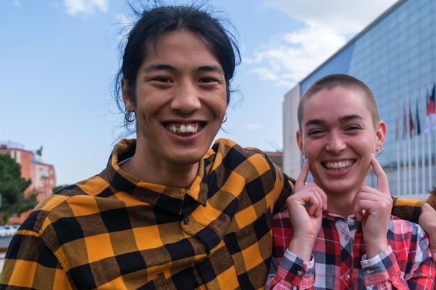 Two friends of different ethnic groups in checkered shirts outdoors