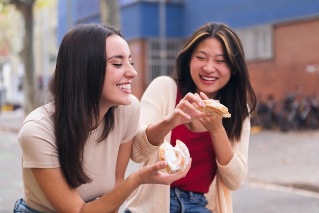 Two friends laughing and having fun in a city park