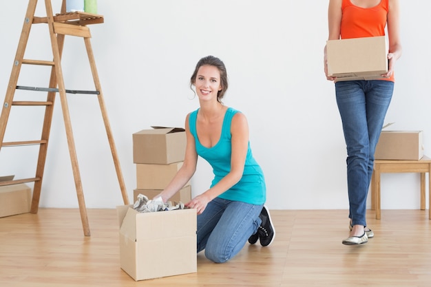 Two friends moving together in a new house