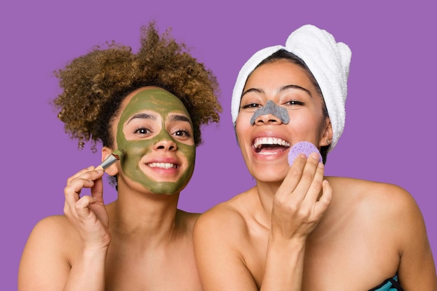 Two friends pamper themselves with facial treatments for a relaxing spa day at home