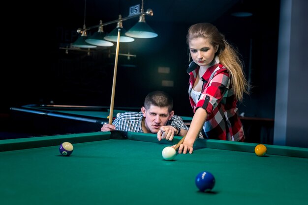 Two friends playing billiard, recreation and gambling