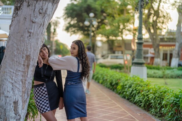 Two friends posing relaxed in a park