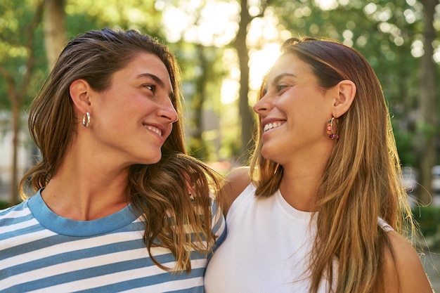 Two friends smiling happily in a park