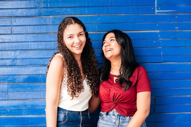 Two friends women using brackets laughing together