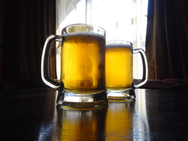 Two full glasses of craft beer on the table at pub