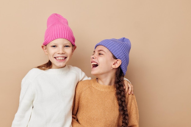 Two funny little girls in colorful hats