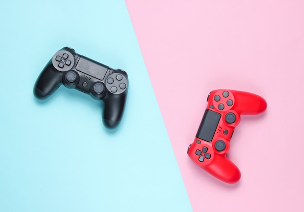 Two gamepad on a colored paper background. Video game.