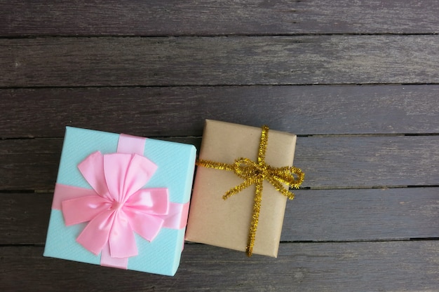 Two gift boxes on the brown wooden background