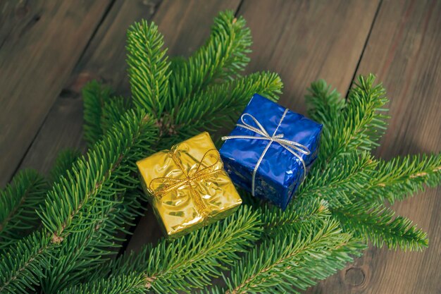 Two gifts on the christmas tree presents on a spruce branch