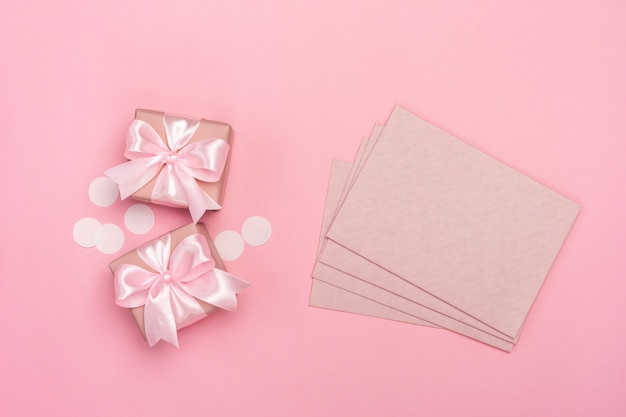 Two gifts or presents boxes on pink pastel.