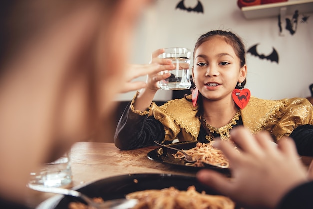 Two girl in costume having lunch