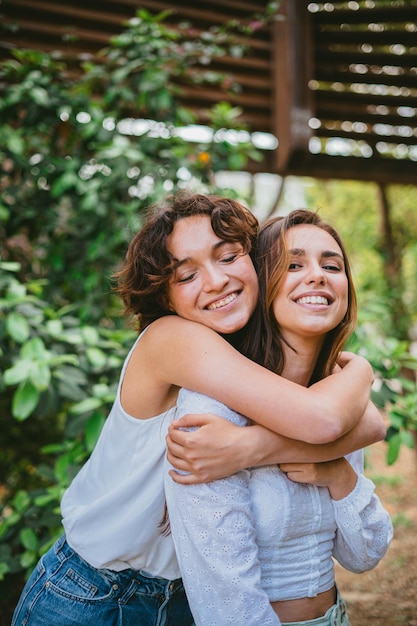Two girl friends hugging