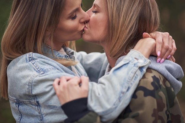 Two girl friends or lgnt couple in wood