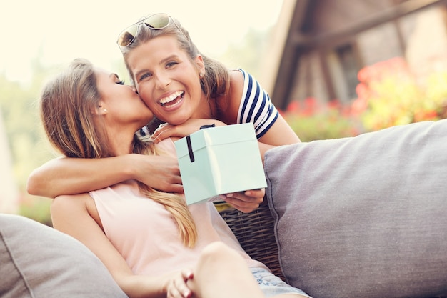 two girl friends making a surprise birthday present