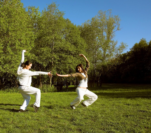 Two girl jumping in park