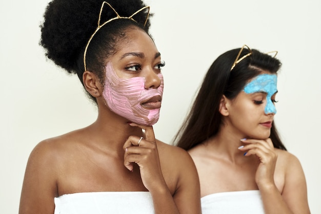 Two girlfriends or young women in love try multimasking on themselves.