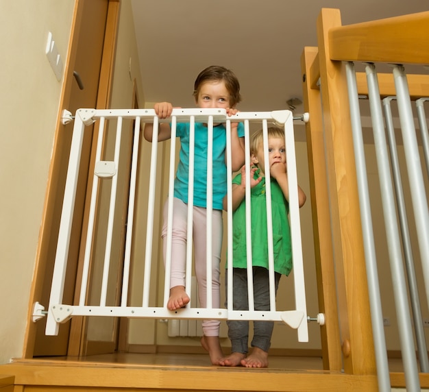 Two girls approaching safety gate 