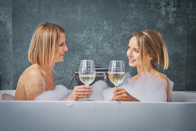 Two girls or couple in bathroom having fun