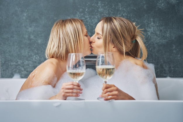 Two girls or couple in bathroom having fun