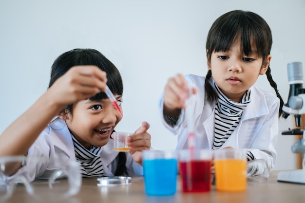 Two girls doing science experiments in a lab. Selective focus.