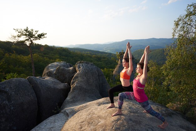 Two girls doing stretching exercises