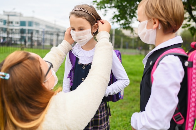 Photo two girls on the first day of school with protective masks