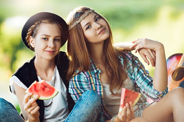 Two girls having picnic in the park