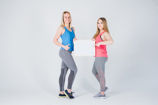 Two girls holding the frame