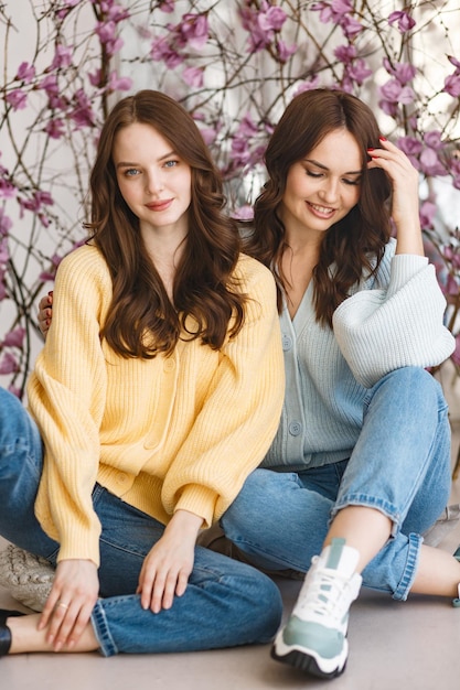 Two girls models have fun and smile in a photo studio Expression of emotions